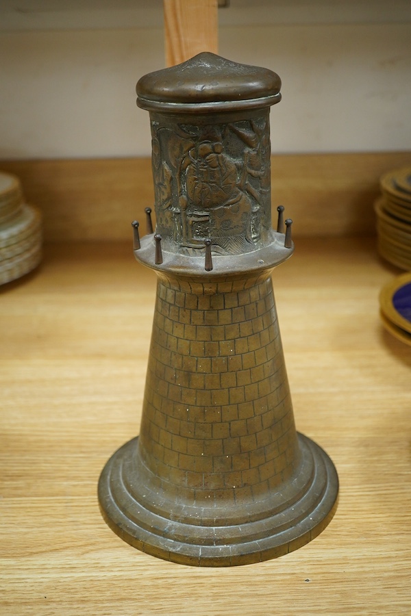 A bronze 'lighthouse' clock case with Chinese repoussé decoration, 30cm. Condition - fair to good